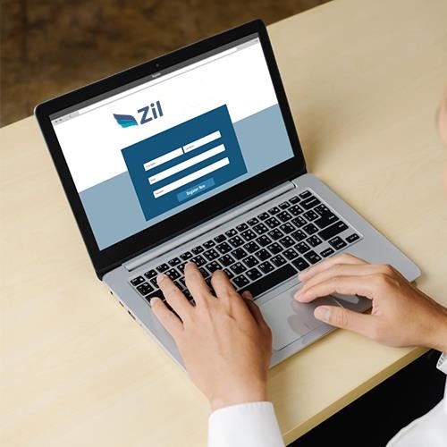 A Person Using a Laptop with the Bank Logo on It, Accessing Their Online Free Business Checking Account