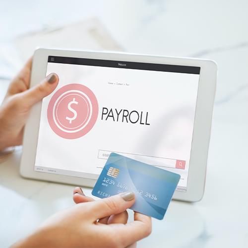 A Person Holding a Tablet Displaying the Word Payroll, Symbolizing Payroll Cards for Employees