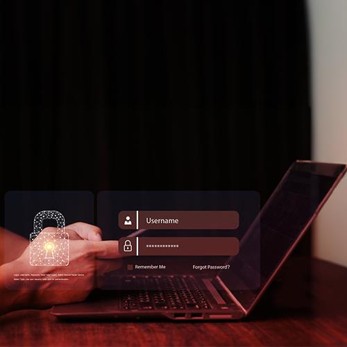 A Person Using a Laptop Displaying a Fintech Software Security Screen, Symbolizing Secure Online Financial Transactions.