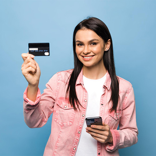 A Woman Confidently Holding a Card and Smartphone, Symbolizing Instant Money Transfer To A Debit Card, Showcasing Digital Transaction Ease
