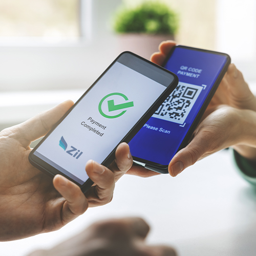 Two Hands Holding Smartphones Facing Each Other; One Displays a QR Code and the Other a Payment Confirmation Message with a Green Check Mark, Showcasing QR Code Payments - a Powerful Tool to Revolutionize Transactions.