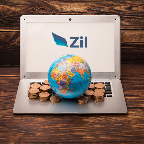 A Globe and Scattered Coins Rest on an Open Laptop, Showcasing the Ease of Best International Wire Transfer