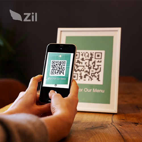 A Person Uses a Smartphone to Scan a QR Code from a Framed Picture. He Is Engaged in the Payment QR Code Process