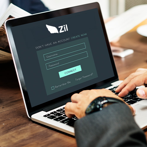 How BlueVine Bank Alternative, Zil Ensures Safe Transactions: a Person in a Business Suit Is Logging into an Account on a Laptop.