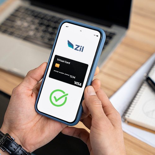 A Hand Holding a Smartphone Showing Zil Checking Account. Empower Businesses with the Enhanced Financial Control of Virtual Card Free