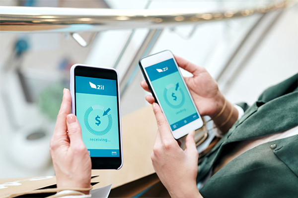 Two Hands Holding 2 Smartphones Sending Direct Deposit. Make Your Transactions Easier