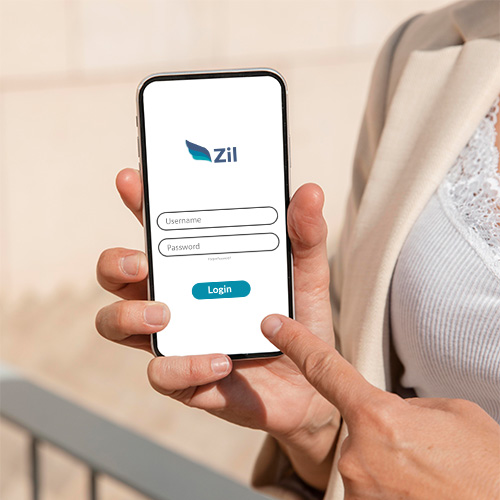 A Person Holding a Smartphone Displaying a Login Screen of Zil to Open Instant Checking Account Online