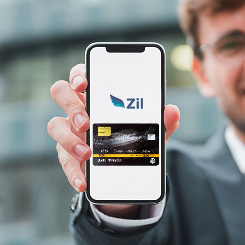 A Person Is Holding a Smartphone, Displaying the Zil App Interface with a Digital Representation of Customizable Card