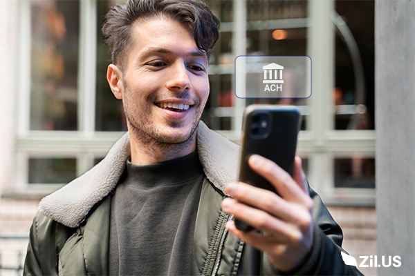 A Man Holding a Smartphone Showing an ACH Payment. Simplify Business Payments & Control